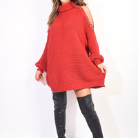 Red knitted oversized jumper with high neck, long sleeves, and open shoulder detail