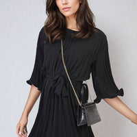 Black pleated mini dress with tie waist and flowing wide bell sleeves
