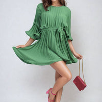 Green pleated mini dress with tie waist and loose three-quarter wide sleeves