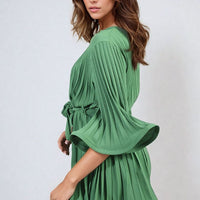Green pleated mini dress with tie waist and flowing wide sleeve cuffs
