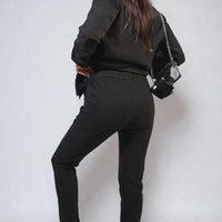 Black drawstring tapered trousers with side pockets, back and side view