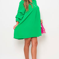 Bright green shirt dress with collar and gathered waist seam, mini length.