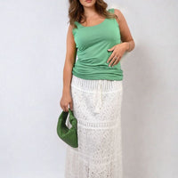 Green scoop-neck tank top with wide shoulder straps and ruched drape front.