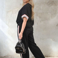 Black co-ord set with short-sleeve top and wide-leg trousers, striped sleeve and side trims