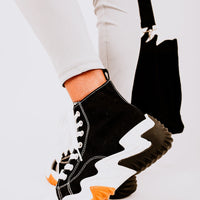 Black high-top platform trainers with white laces and chunky contrast sole