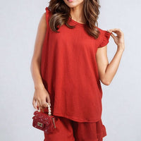 Red sleeveless top and matching shorts set with ruffle hem trim.