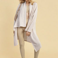 White open-front long knitted cardigan with shawl collar, draped front, long sleeves.