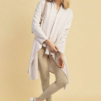 White open-front long knitted cardigan, long sleeves and flowing drape, textured knit.