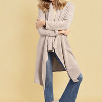 Light beige open-front long knitted cardigan, loose drape, long sleeves.