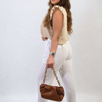 White high-waist drawstring trousers with side pockets and relaxed cuffed hems