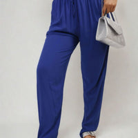 Royal blue high-waist drawstring pants with side pockets and tapered ankle shape
