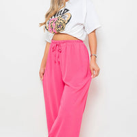 Fuchsia pink wide-leg trousers with gathered drawstring waist, side view