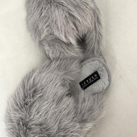 Grey faux fur open-back slippers, side view with small logo patch on cuff