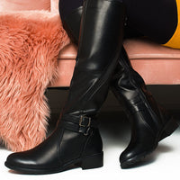 Black knee-high boots with buckle strap and chunky low heel