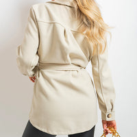 Beige belted jacket viewed from the back, with tied waist and flap pockets.