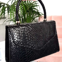 Faux Leather Handbag in Lilac with Top Handle and Chain Strap