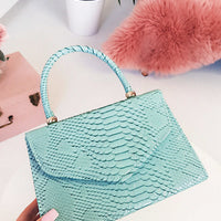 Faux Leather Handbag in Lilac with Top Handle and Chain Strap