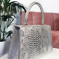 Faux Leather Handbag in Lilac with Top Handle and Chain Strap