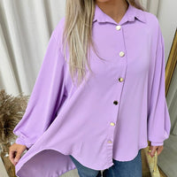 Oversized collared lilac button-down top close-up with front buttons and roomy long sleeves