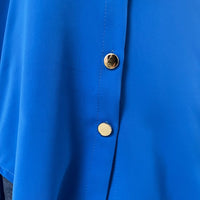Royal blue button-down top close-up with collar seam and round front buttons