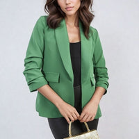 Open-front ruched-sleeve blazer jacket in green with front pockets and folded cuffs.