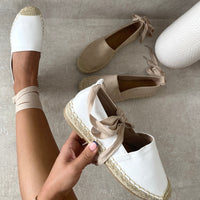 Espadrilles with ankle ties, woven jute toe caps, and braided platform sole