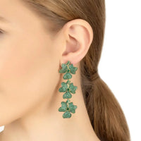 Triple drop green flower earrings on ear, gold-tone hooks