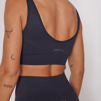 Petite seam-free sports bra in navy with racerback and open back, sleeveless