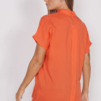Red-orange utility shirt with short sleeves and relaxed cut, back view