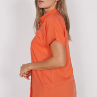 Red-orange utility shirt with short sleeves and relaxed fit, side view
