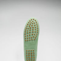 Driving loafer sole with rows of tan rubber grip studs.