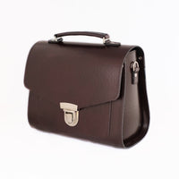 Marsala red leather satchel with top handle and front buckle clasp, side view
