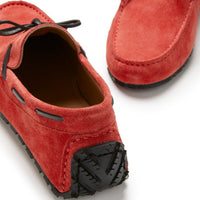 Red suede driving loafers with black laces and textured rubber heel pads