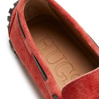 Red suede loafer showing the tan insole and black side lacing