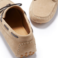 Taupe suede driving loafer showing the stitched heel, leather lining, and rounded sole pegs