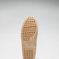 Driving loafer sole with rounded rubber traction pegs at the toe and heel