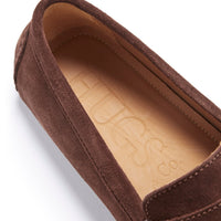 Close-up of brown suede loafer with tan insole and Hugs & Co. branding