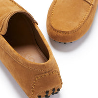 Tan suede driving loafer detail with stitched heel, apron toe, and rubber sole pods.