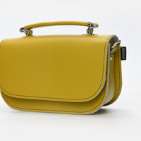 Yellow ochre leather mini bag with adjustable strap and flap front