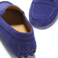 Suede loafer detail showing heel studs, stitched toe, and tan lining