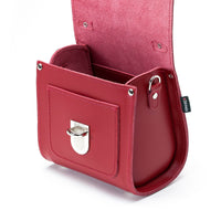 Red leather handbag interior with side pocket and silver clasp on front flap