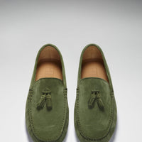 Pair of green suede tassel loafers viewed from above