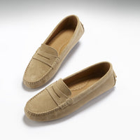 Pair of taupe suede penny driving loafers with stitched moc toes and perforated insoles