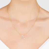Gold-tone zodiac pendant necklace with rhinestone M-shaped star sign symbol