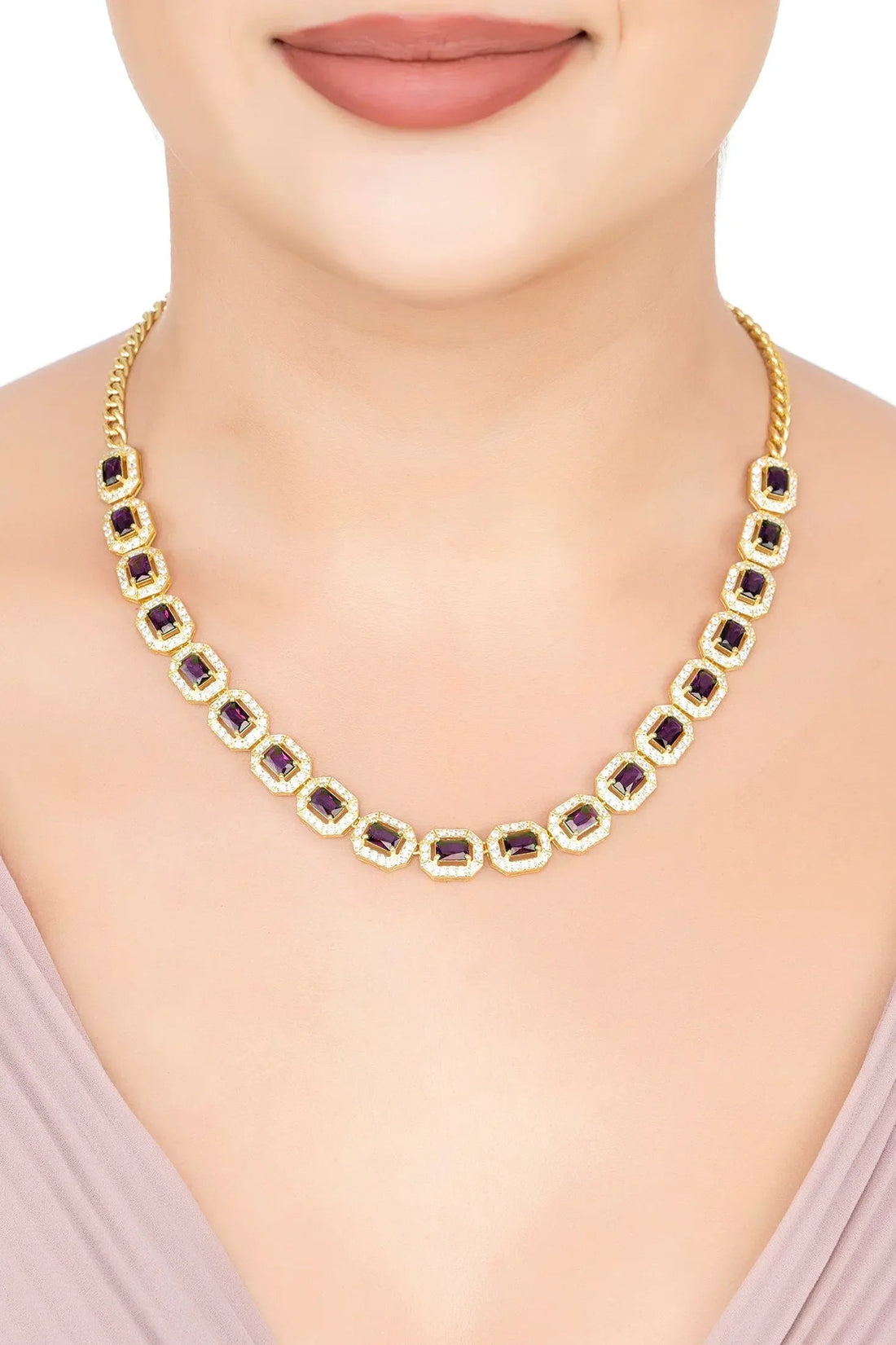 Gold necklace with purple square gemstones in gold frames