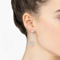 Silver moissanite drop earrings on ear, three stacked stones with a square centerpiece