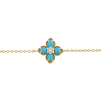 Gold-tone chain bracelet with blue flower clover charm and turquoise enamel detail
