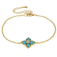 Gold-tone chain bracelet with blue clover charm and turquoise enamel flower