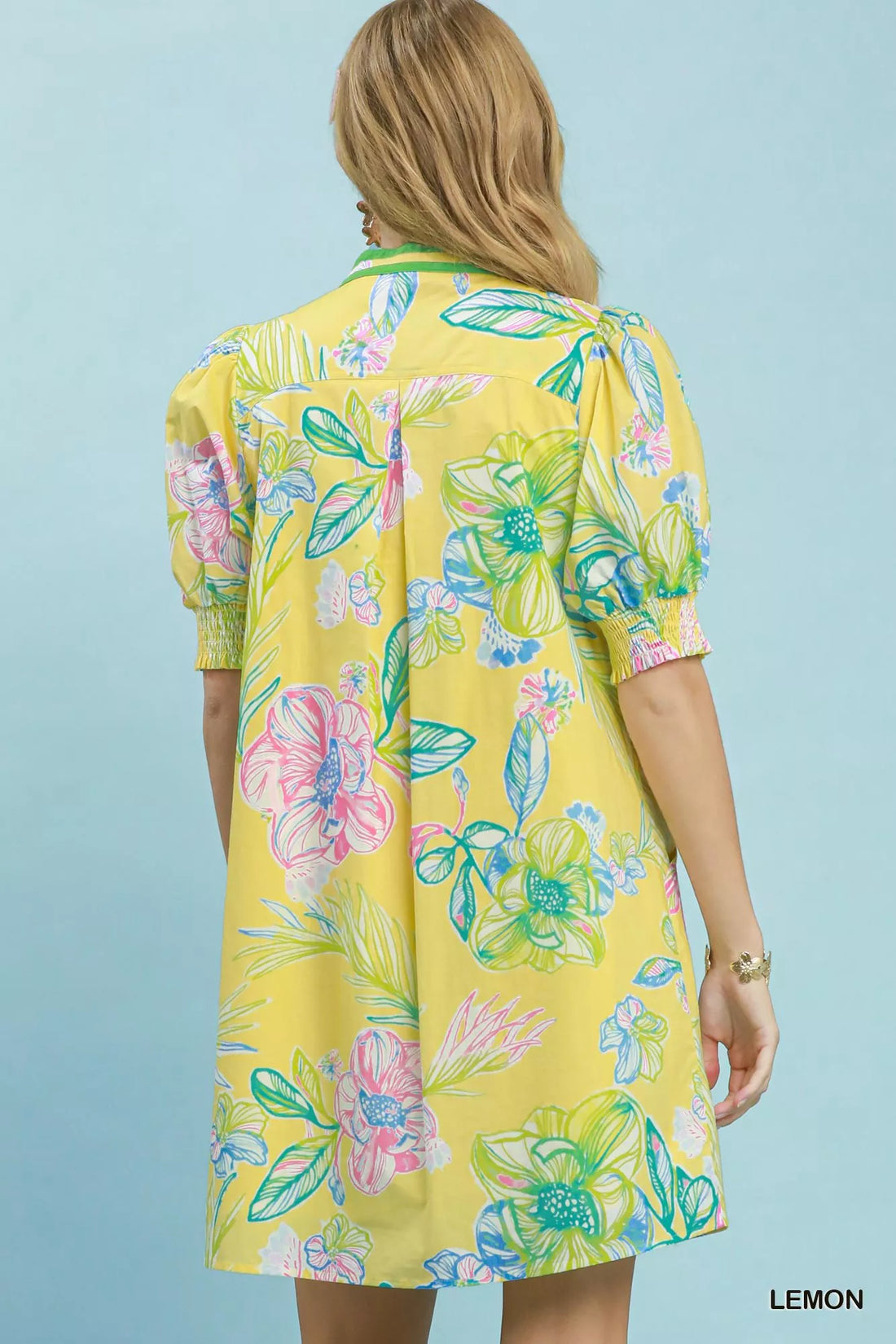 Back view of lemon botanical print dress with short puff sleeves and smocked cuffs