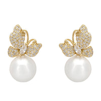 Gold-tone butterfly drop earrings with rhinestone wings and a white pearl drop